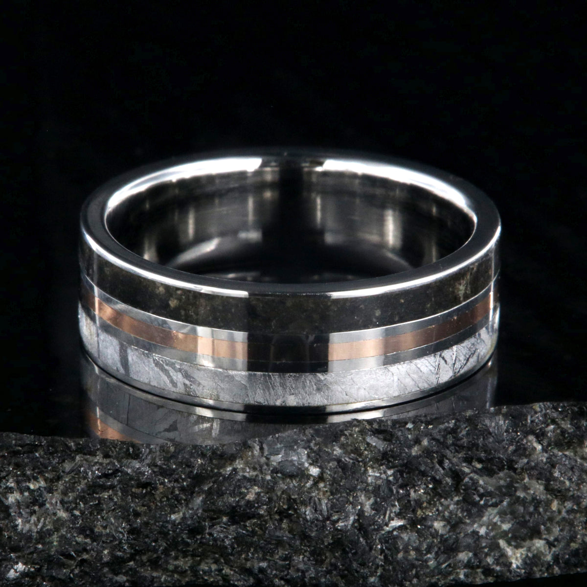 7mm wide wedding band with a center rose gold inlay and dinosaur fossil edge and meteorite edge