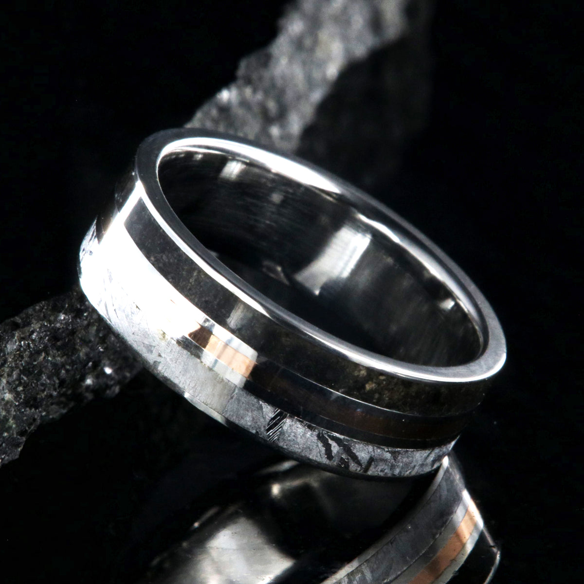 7mm wide wedding band with a center rose gold inlay and dinosaur fossil edge and meteorite edge