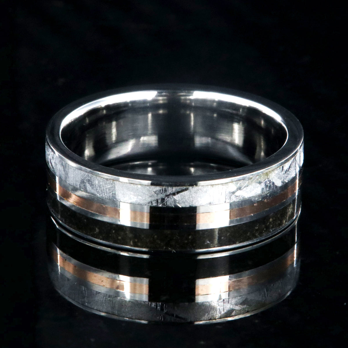 7mm wide wedding band with a center rose gold inlay and dinosaur fossil edge and meteorite edge
