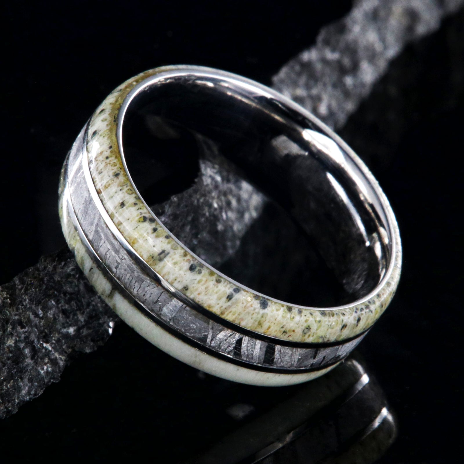 8mm wide men's ring with a center meteorite inlay and antler edges and cobalt sleeve