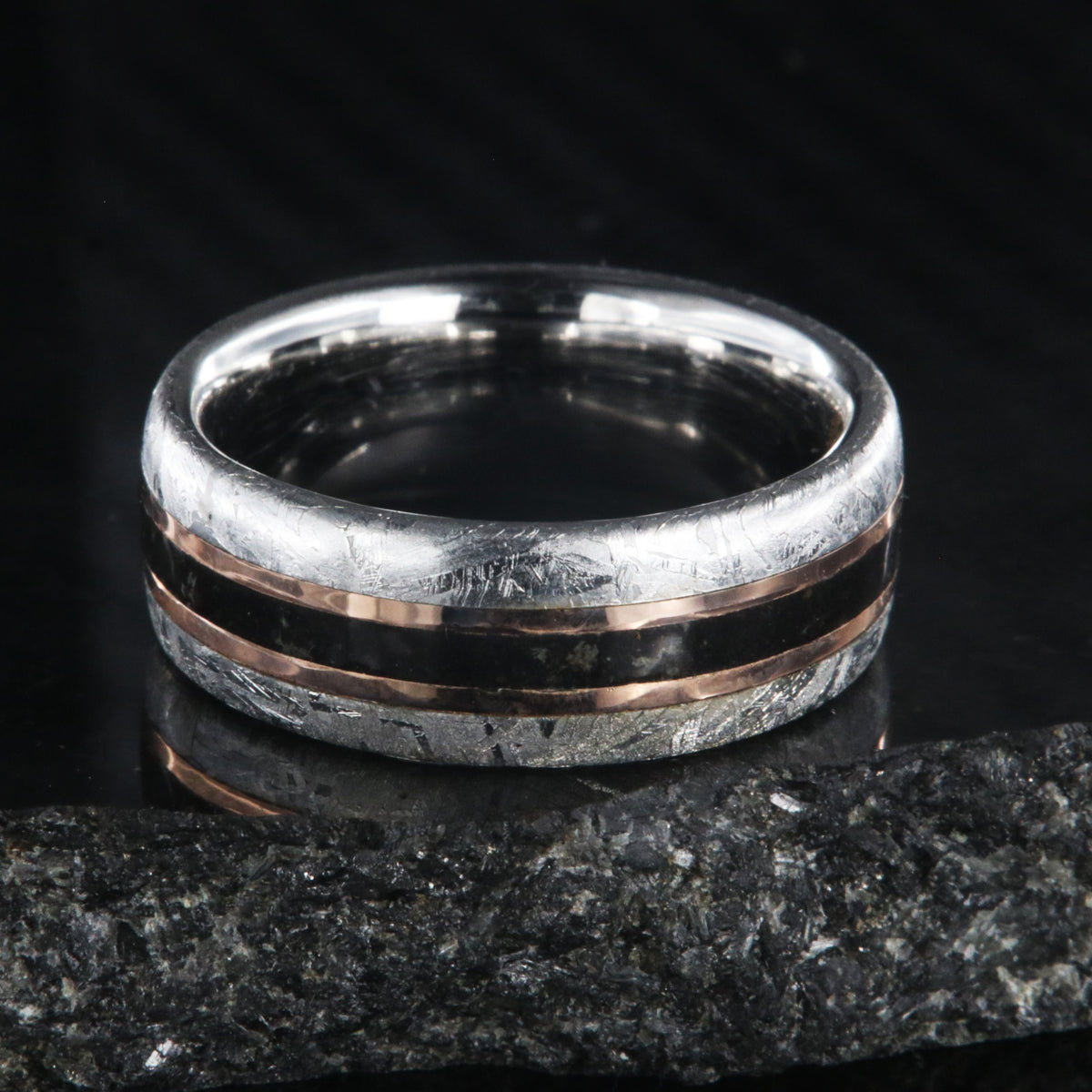 8mm wide men&#39;s wedding band with cobalt sleeve and meteorite edges, a dinosaur bone center inlay with rose gold inlays on either side