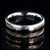 8mm wide men's wedding band with cobalt sleeve and meteorite edges, a dinosaur bone center inlay with rose gold inlays on either side