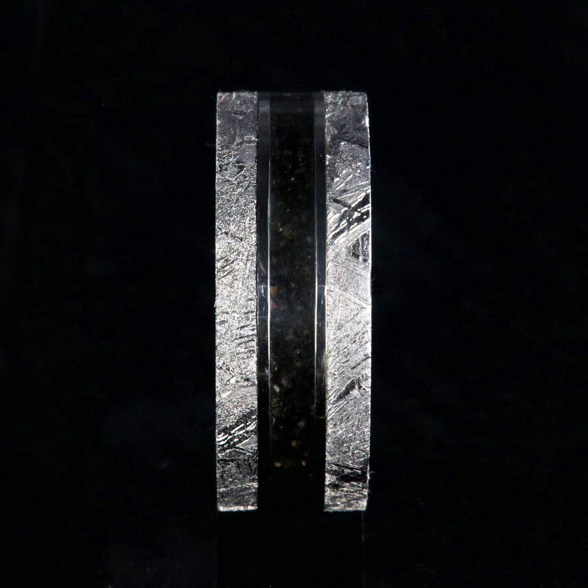 9mm wide men&#39;s wedding band with a dark dinosaur bone center inlay, Gibeon meteorite edges, and a flat profile