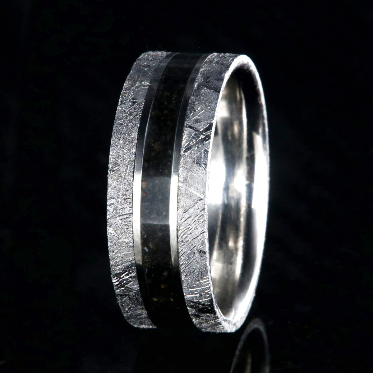 9mm wide men&#39;s wedding band with a dark dinosaur bone center inlay, Gibeon meteorite edges, and a flat profile