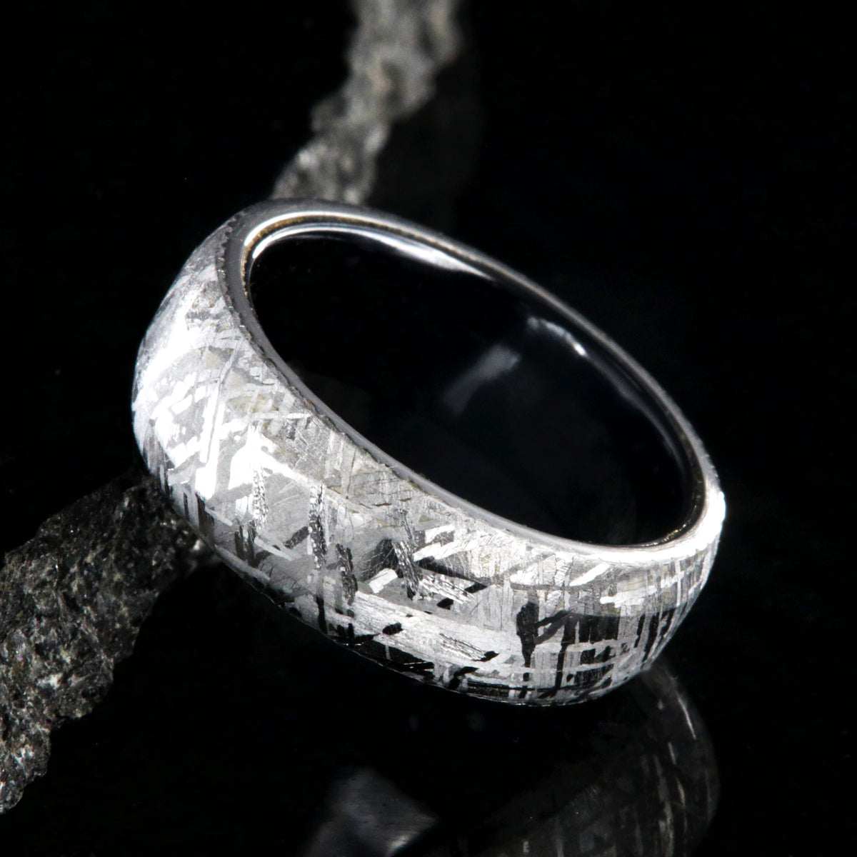 8mm wide Gibeon meteorite wedding band with beveled edges and black titanium sleeve