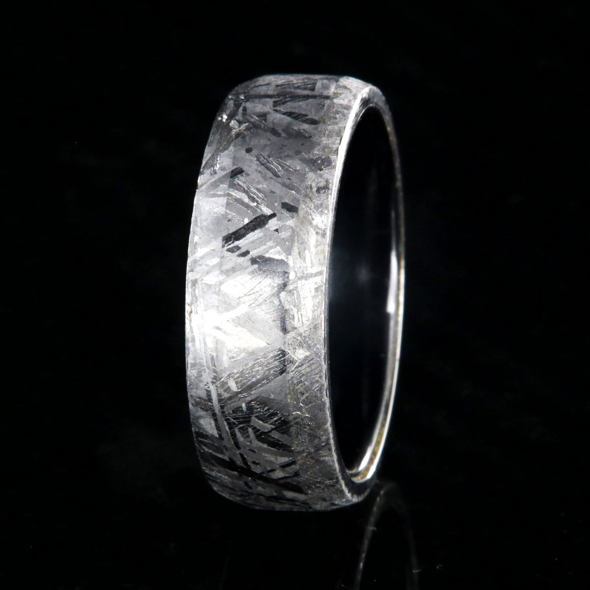 8mm wide Gibeon meteorite ring with black titanium sleeve and rounded profile