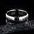 6mm wide white Damascus steel wedding band with rounded profile and off-centered rose gold inlay
