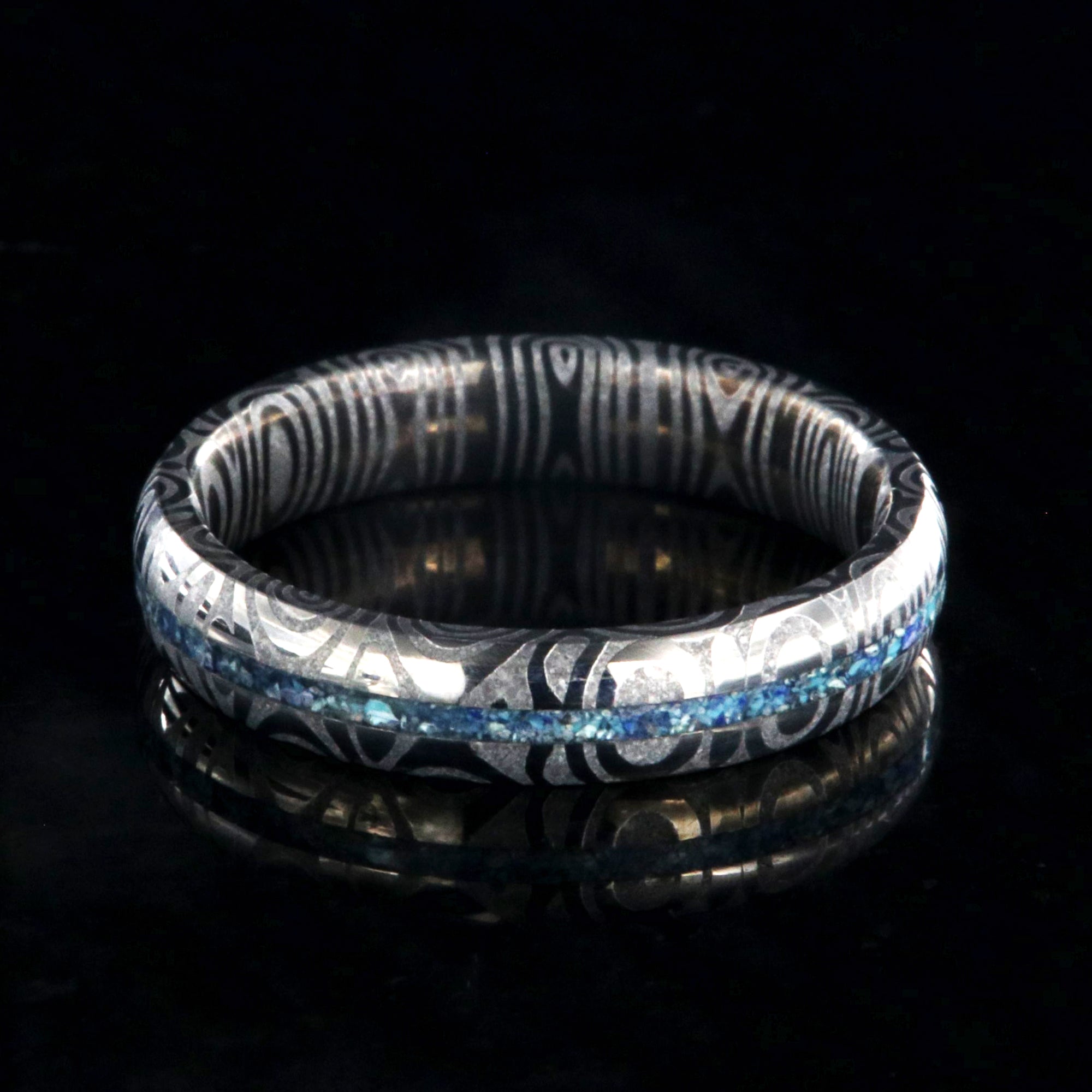 4mm wide Damascus steel ring with a turquoise and lapis lazuli inlay and a rounded profile