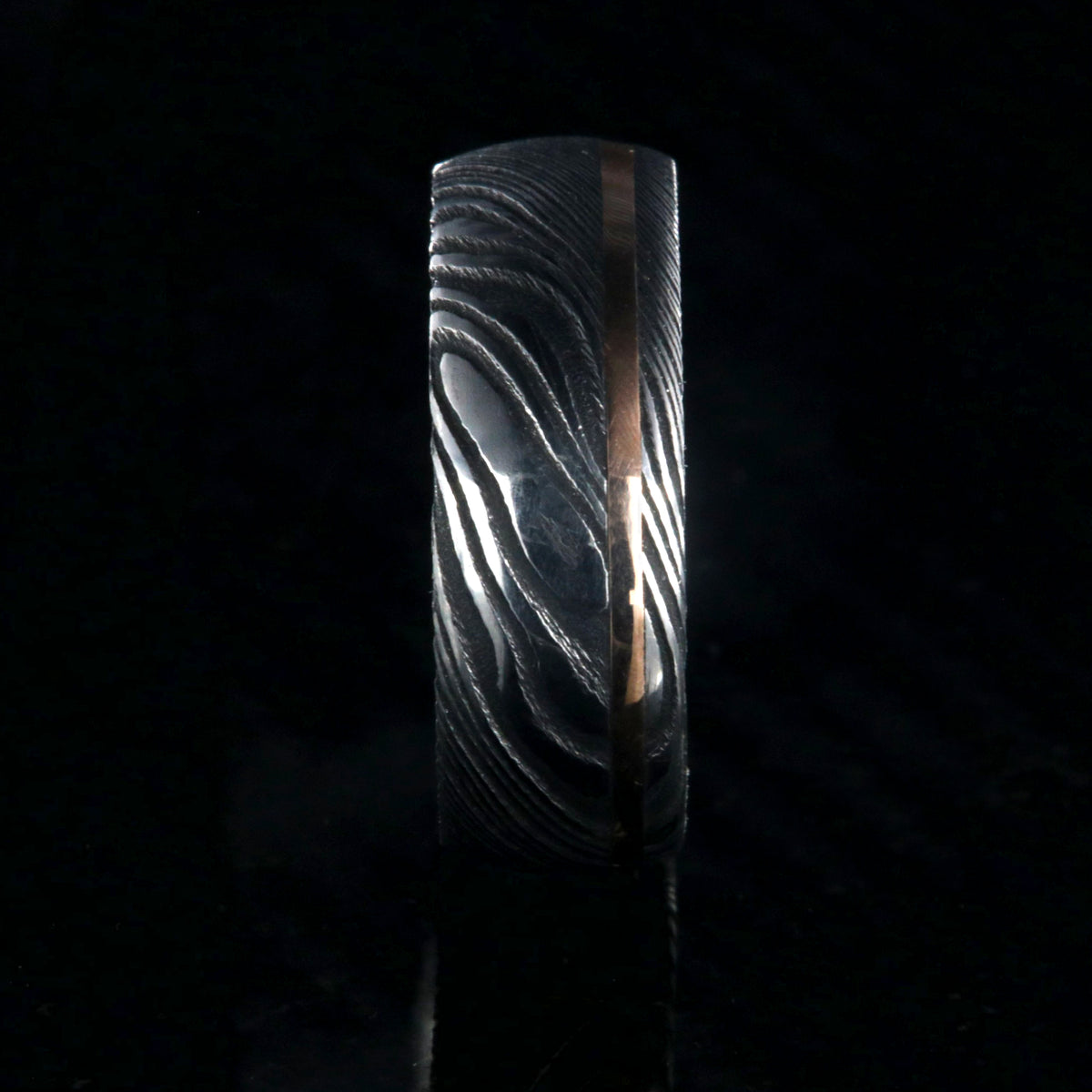8mm wide Damascus steel ring with rose gold inlay