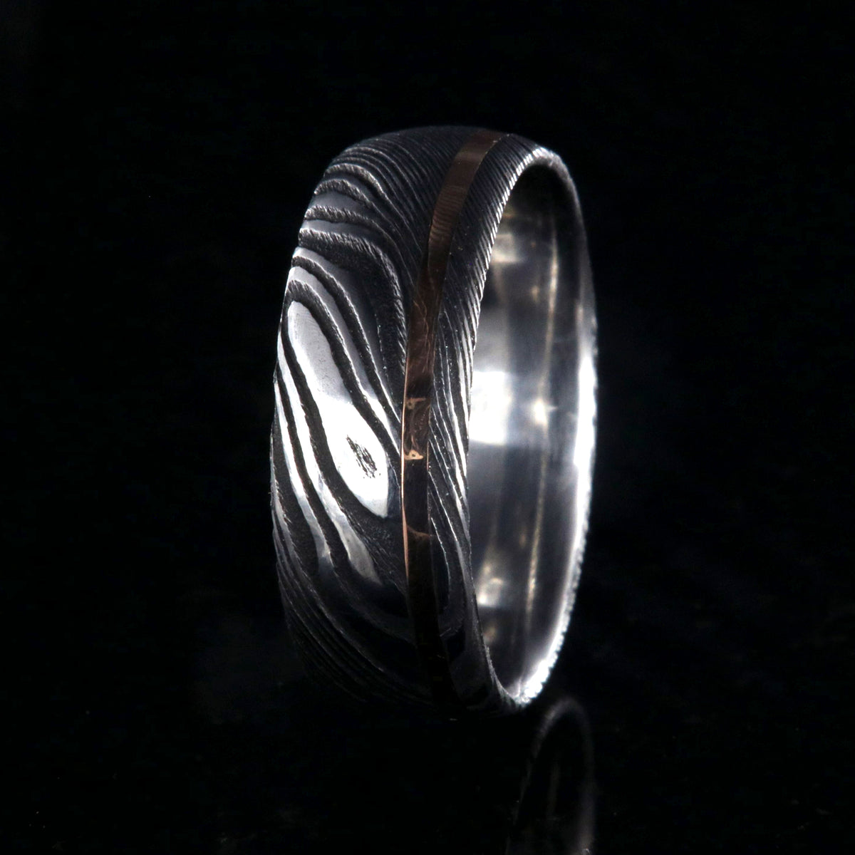 8mm wide Damascus steel ring with rose gold inlay