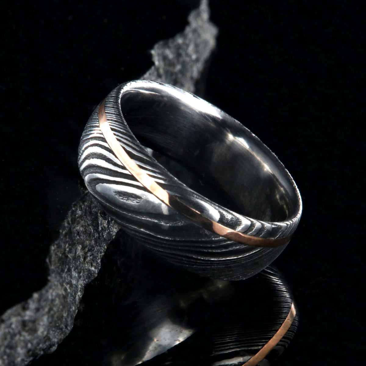 8mm wide Damascus steel ring with rose gold inlay