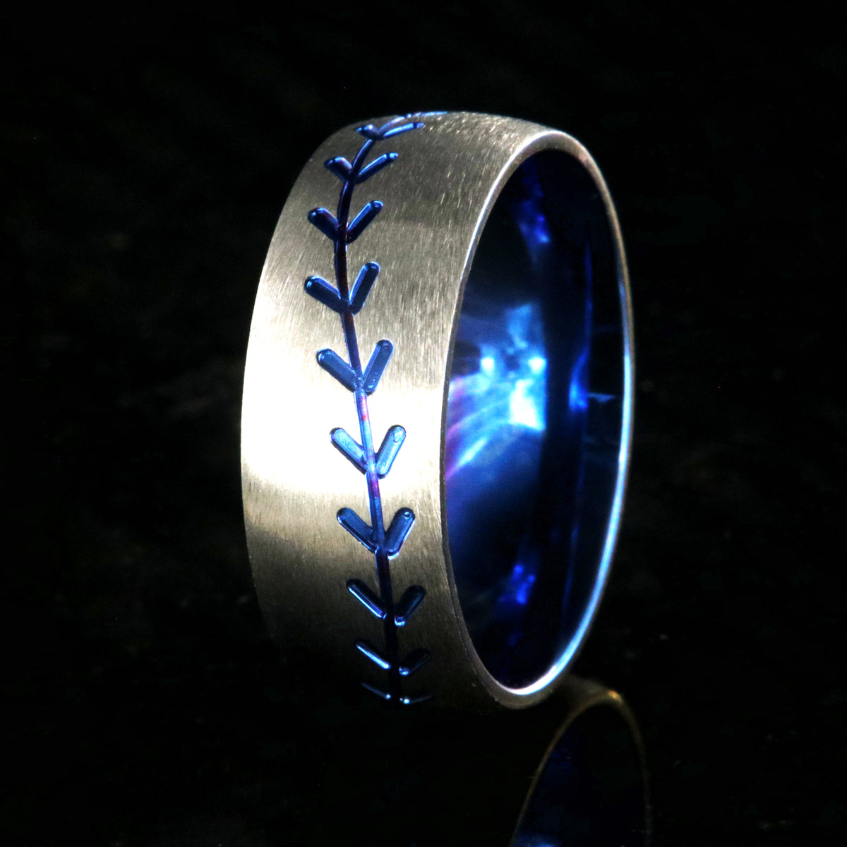 8mm wide titanium baseball ring with blue baseball stitching and a blue sleeve