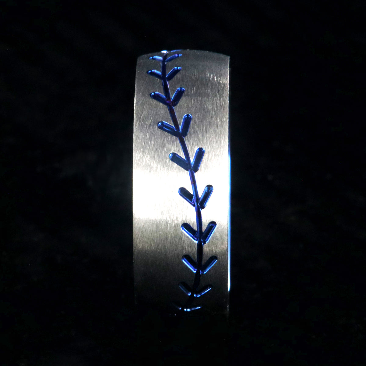 8mm wide titanium baseball ring with blue baseball stitching and a blue sleeve