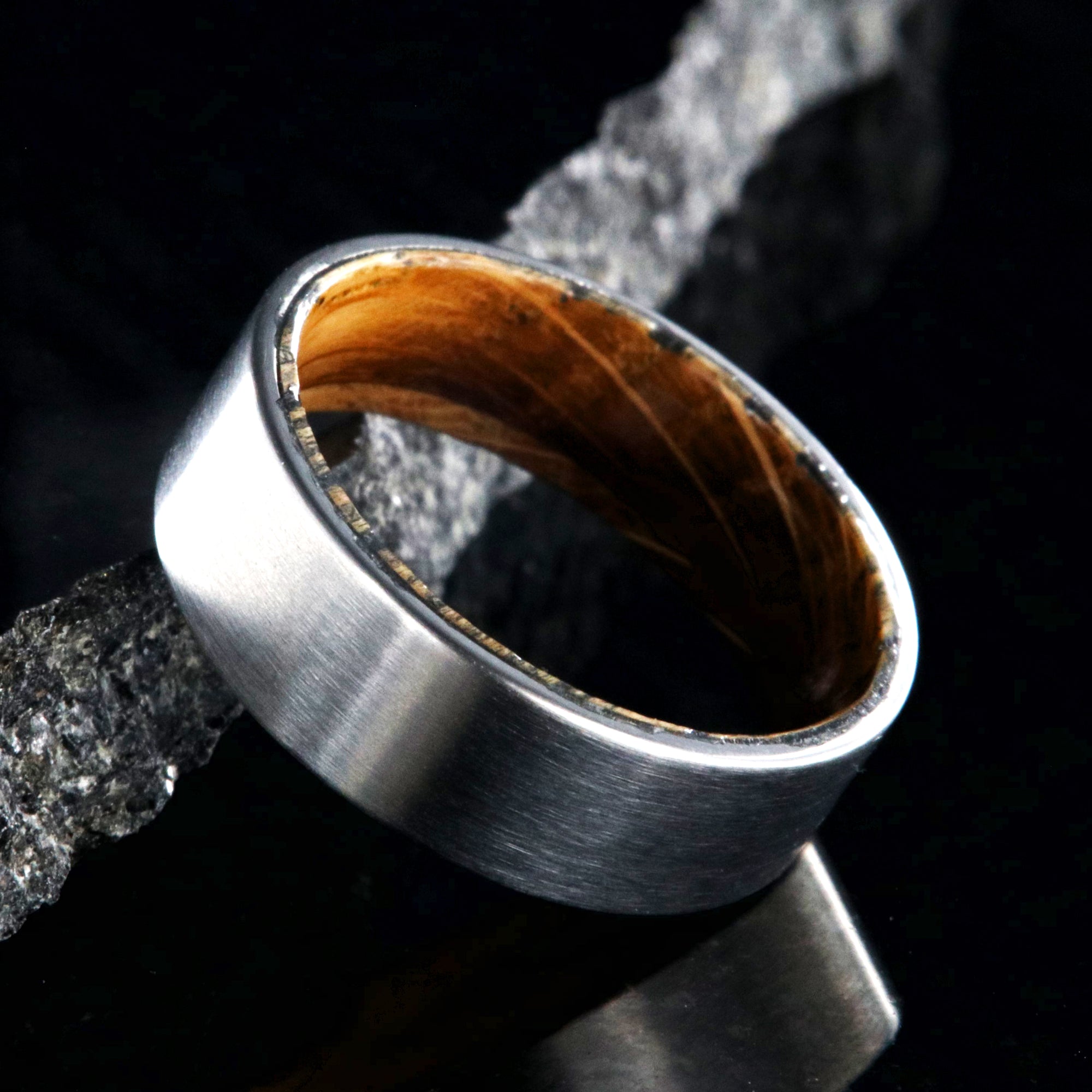 7mm wide titanium wedding band with a flat profile and whiskey barrel sleeve