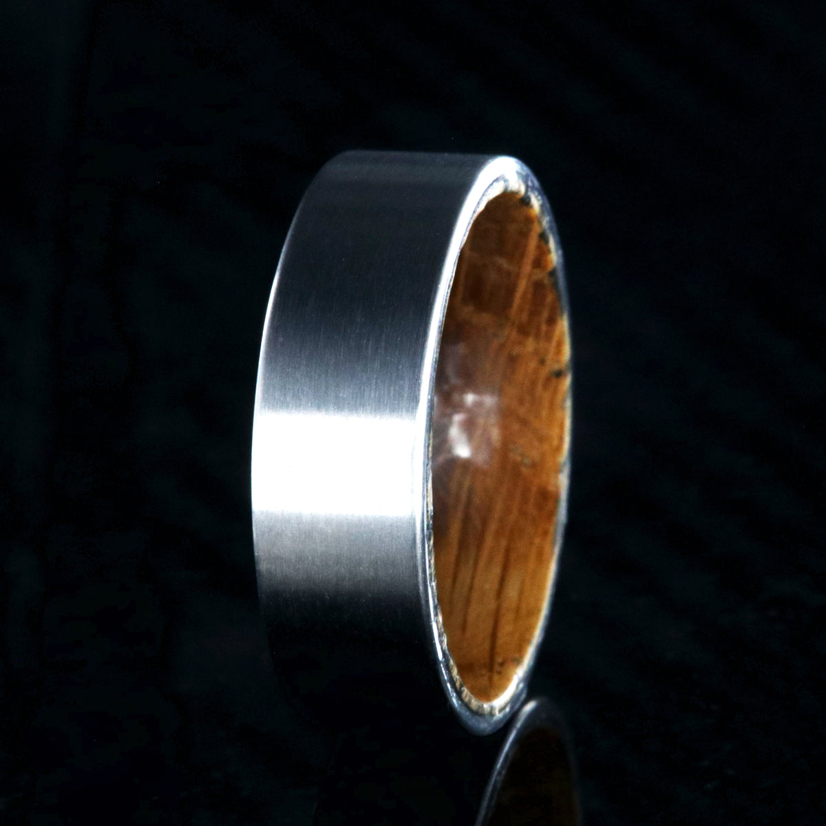 7mm wide titanium wedding band with a flat profile and whiskey barrel sleeve