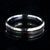 4mm wide titanium wedding band with hammered texture and a 1mm wide t-rex fossil inlay