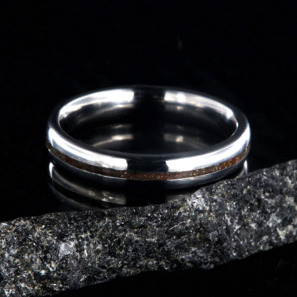 4mm wide titanium wedding band for women with a thin dinosaur bone inlay