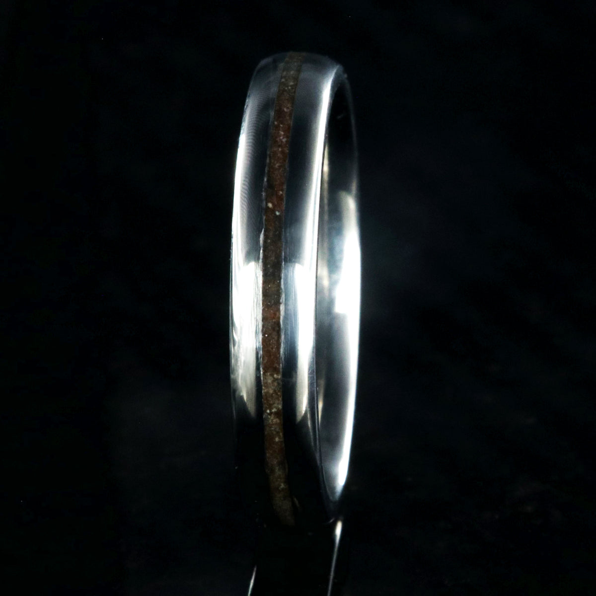 4mm wide titanium wedding band for women with a thin dinosaur bone inlay