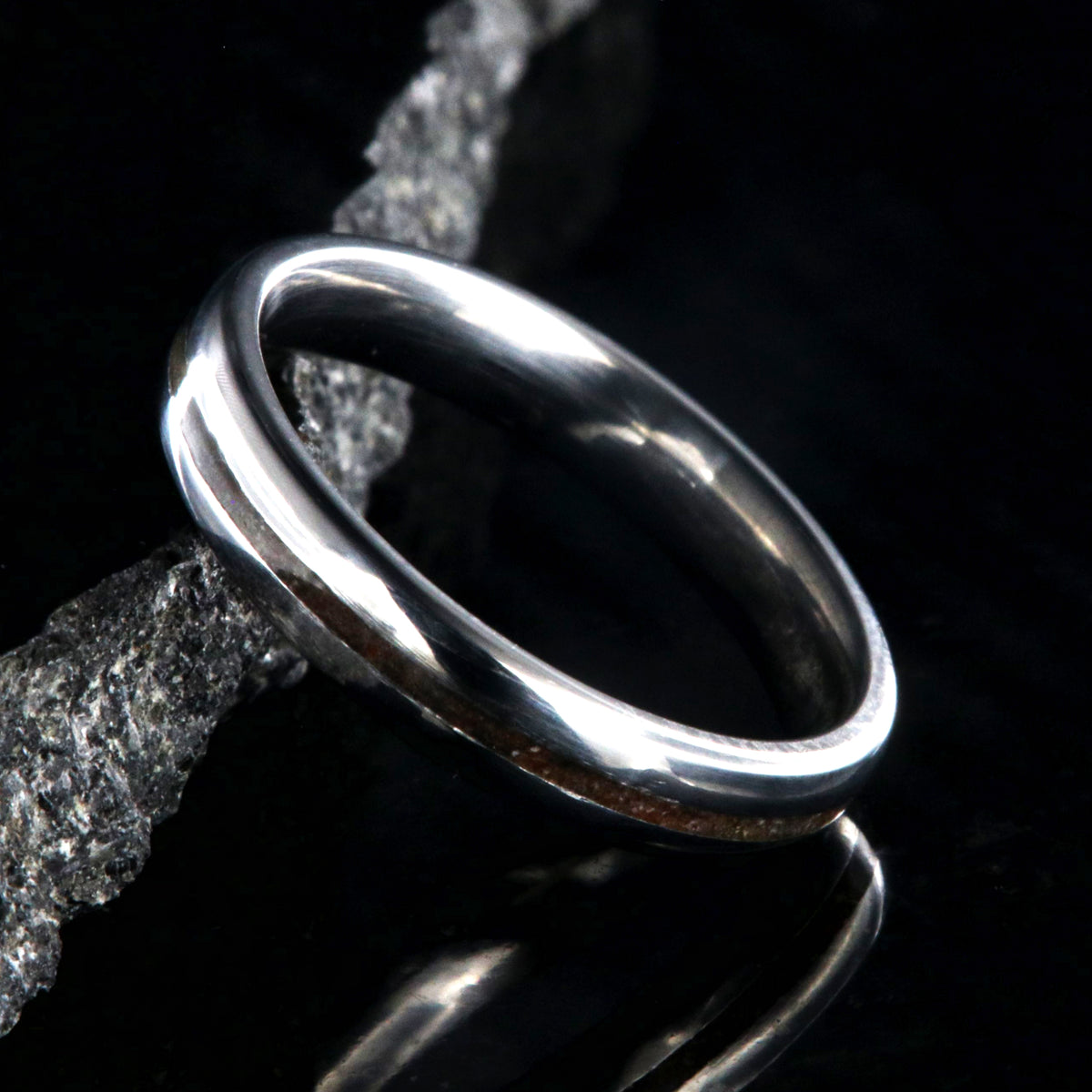 4mm wide titanium wedding band for women with a thin dinosaur bone inlay