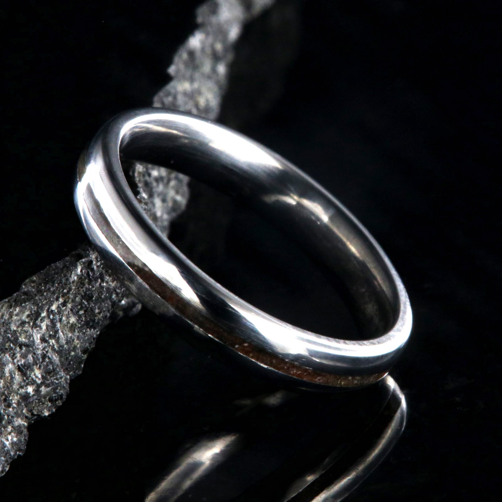 4mm wide titanium wedding band for women with a thin dinosaur bone inlay