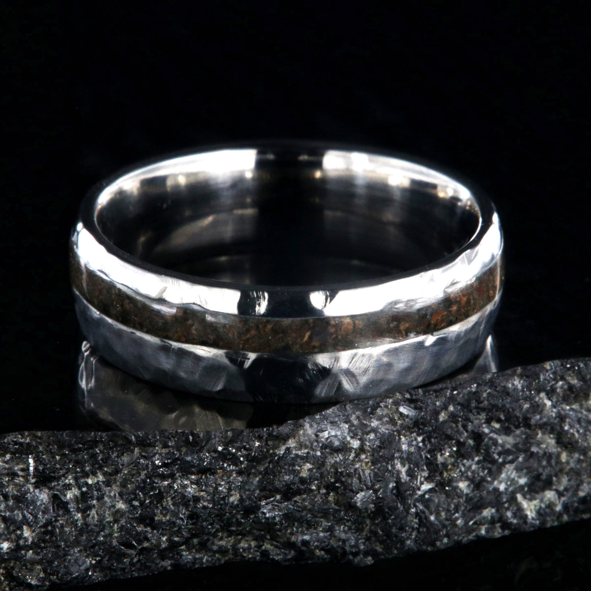 7mm wide titanium wedding band with hammered texture and an off-center 2mm wide t-rex fossil inlay