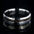 7mm wide titanium wedding band with hammered texture and an off-center 2mm wide t-rex fossil inlay
