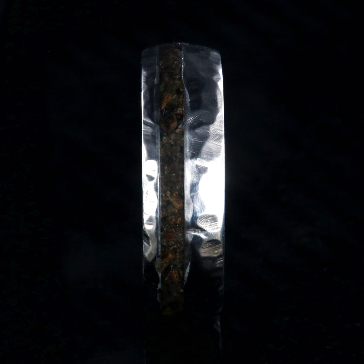 7mm wide titanium wedding band with hammered texture and an off-center 2mm wide t-rex fossil inlay