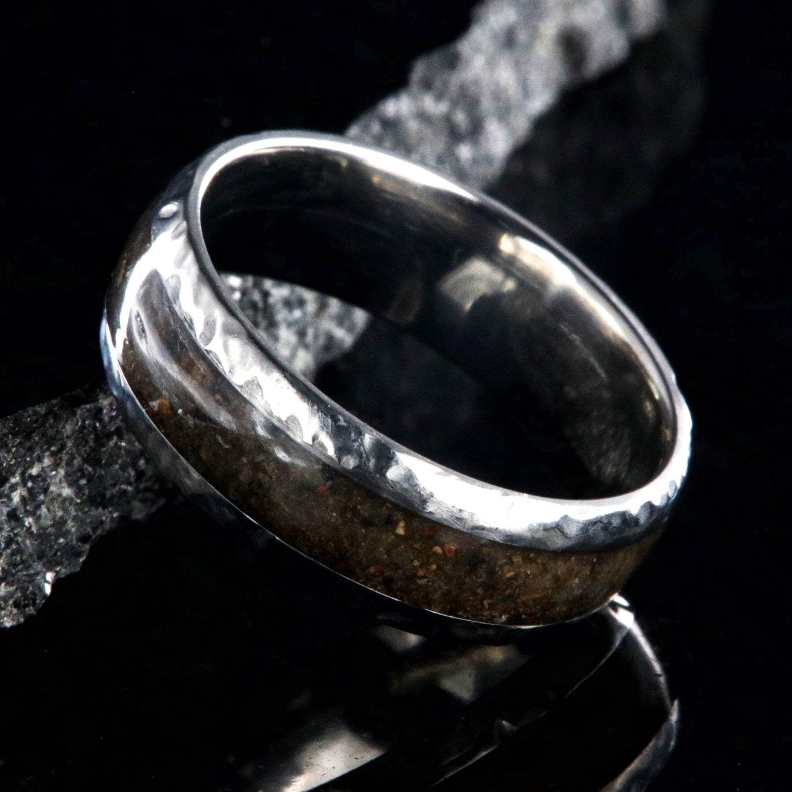 8mm wide titanium ring with hammered edges and a 4mm wide dinosaur bone inlay