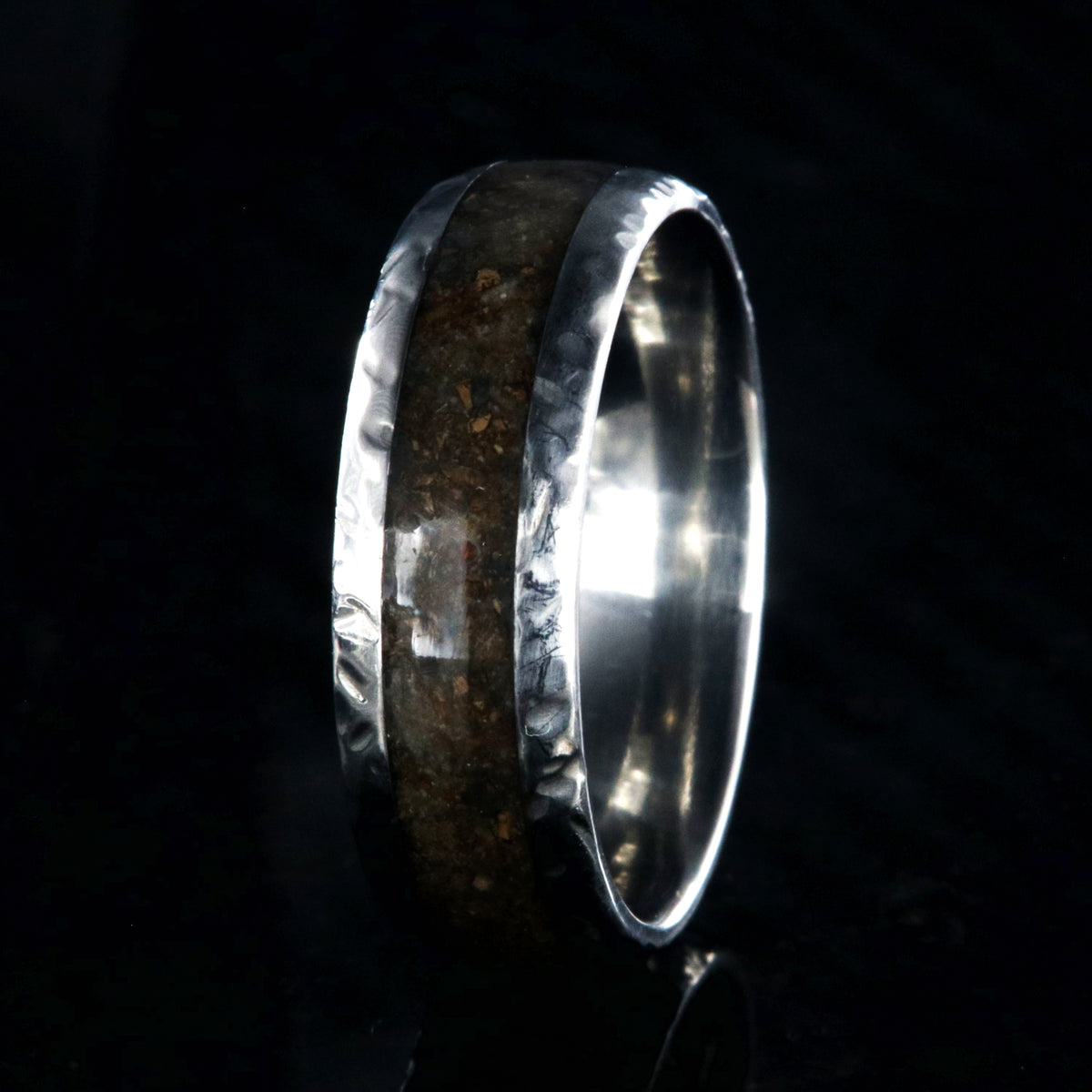 8mm wide titanium ring with hammered edges and a 4mm wide dinosaur bone inlay