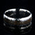 8mm wide titanium ring with hammered edges and a 4mm wide dinosaur bone inlay