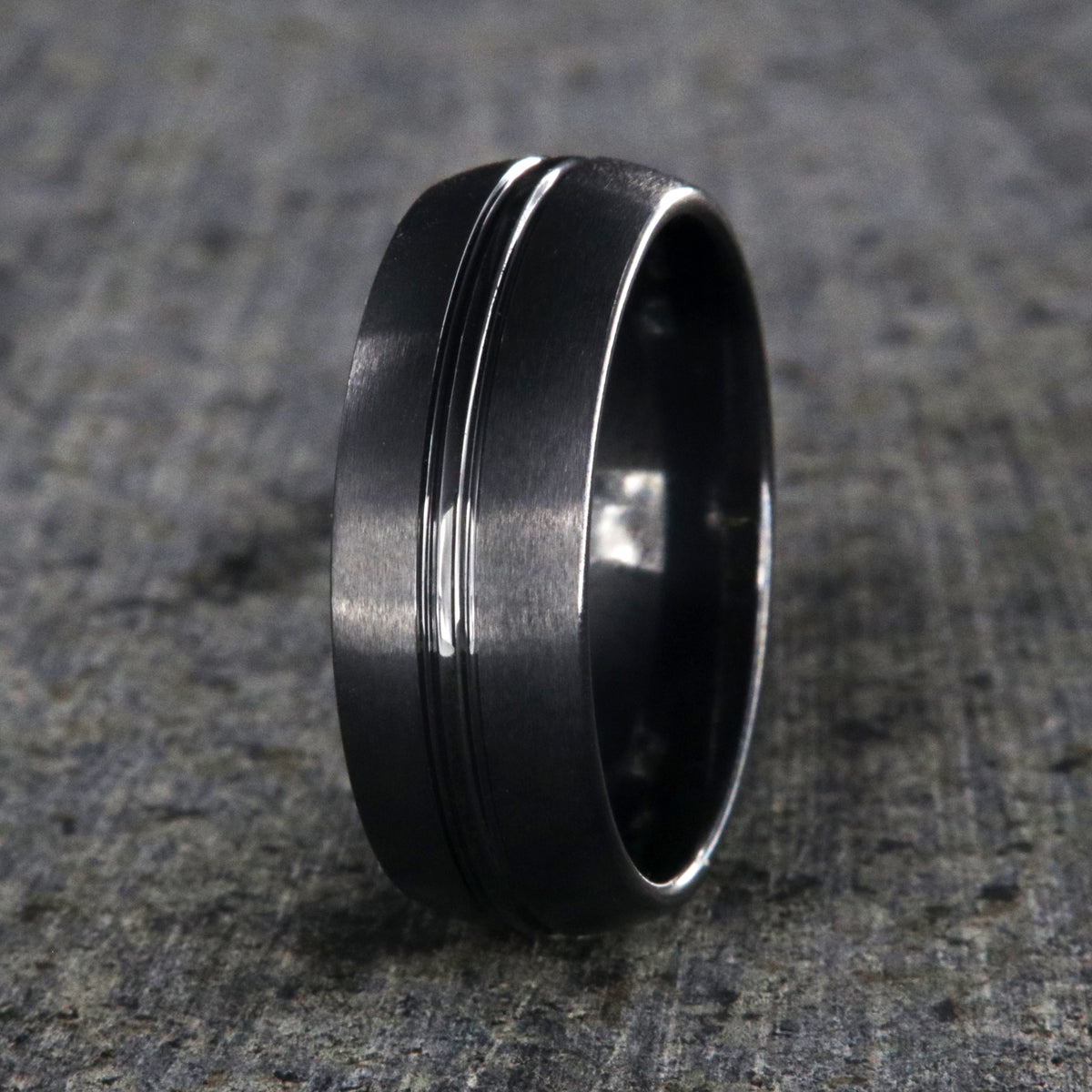 8mm wide black titanium wedding band with a center dual groove and rounded profile