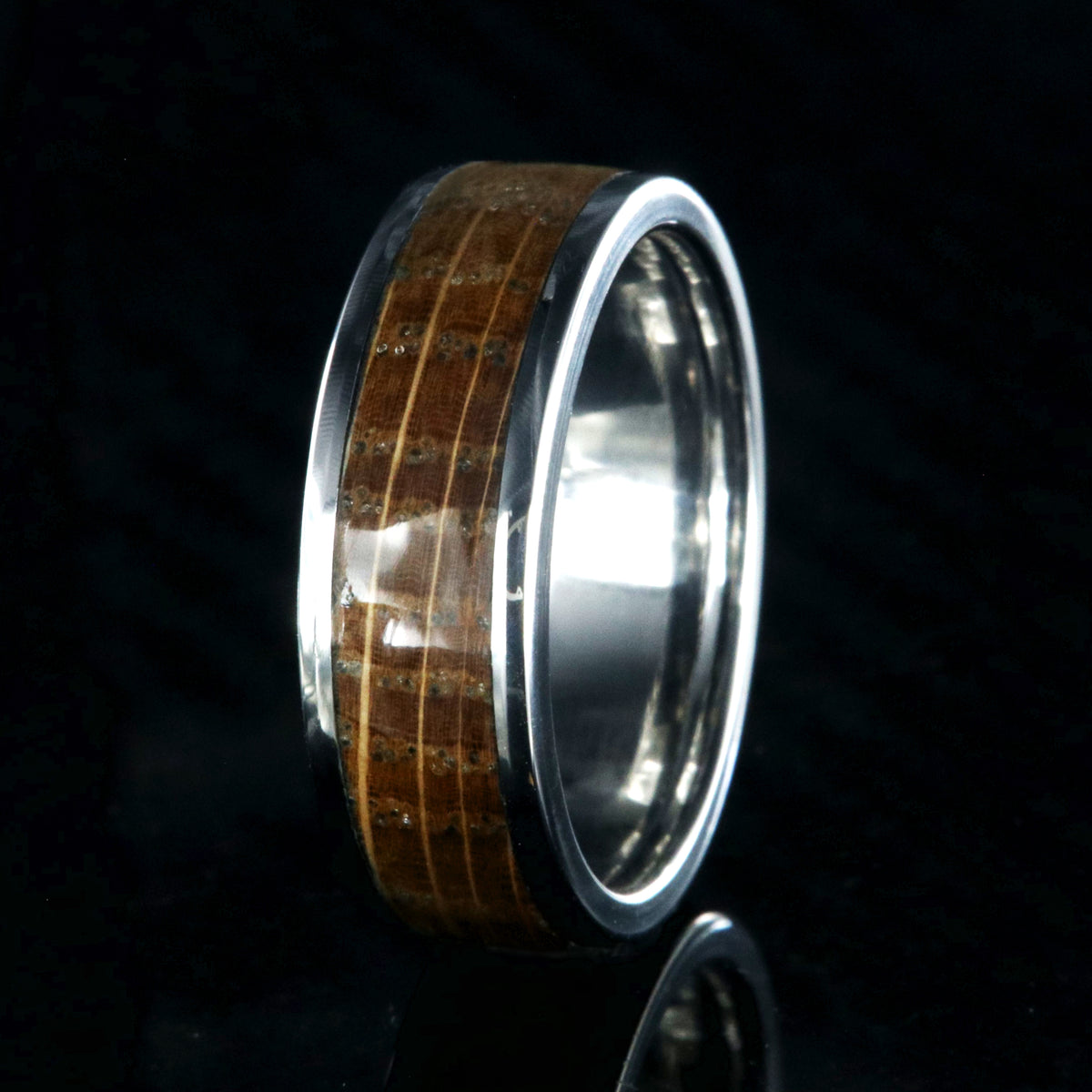 7mm wide wedding band with titanium edges and a whiskey barrel sleeve