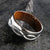 8mm wide titanium wedding band with a milled infinity design with a whiskey barrel sleeve