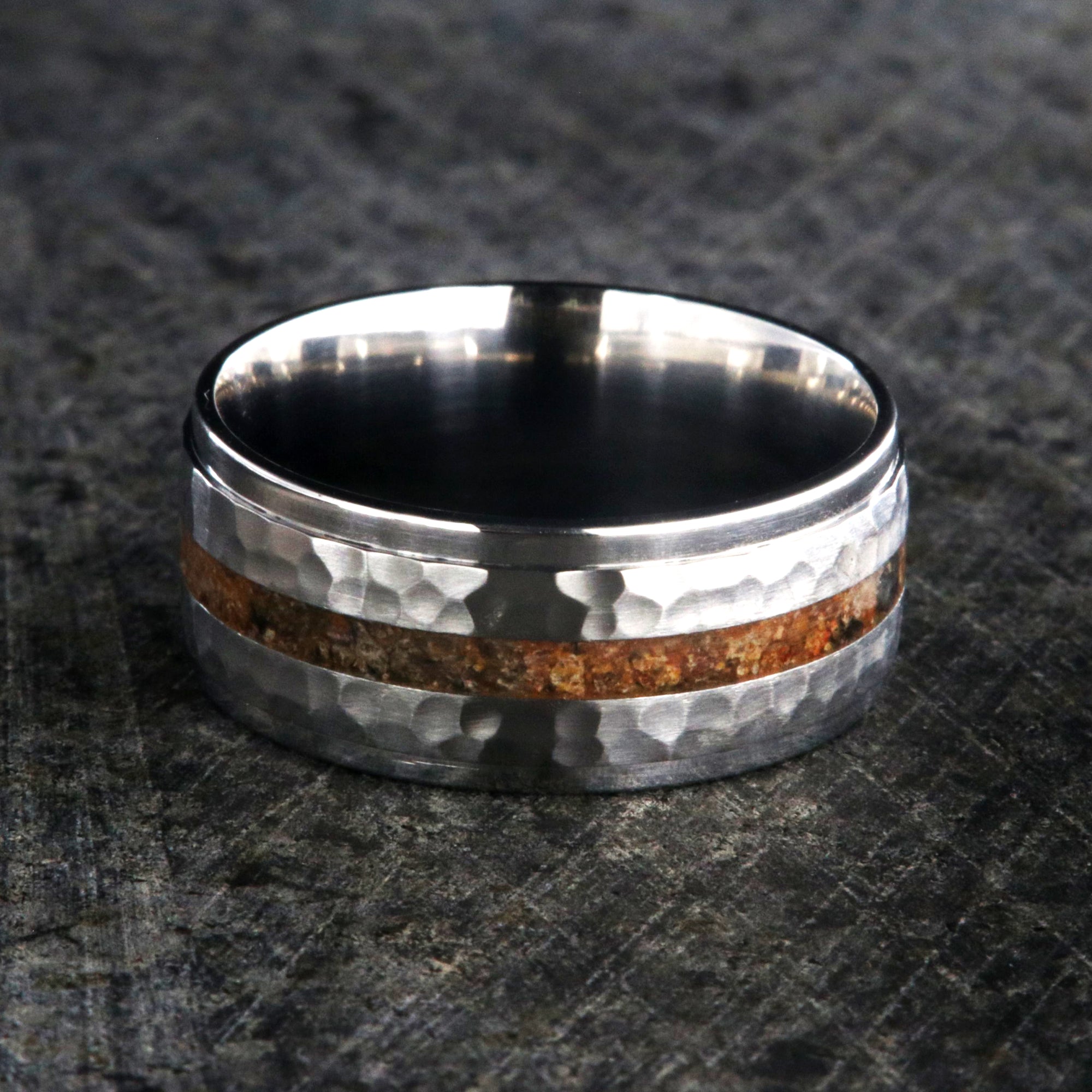 9mm wide titanium wedding band with a dinosaur bone inlay, raised center, and hammered texture