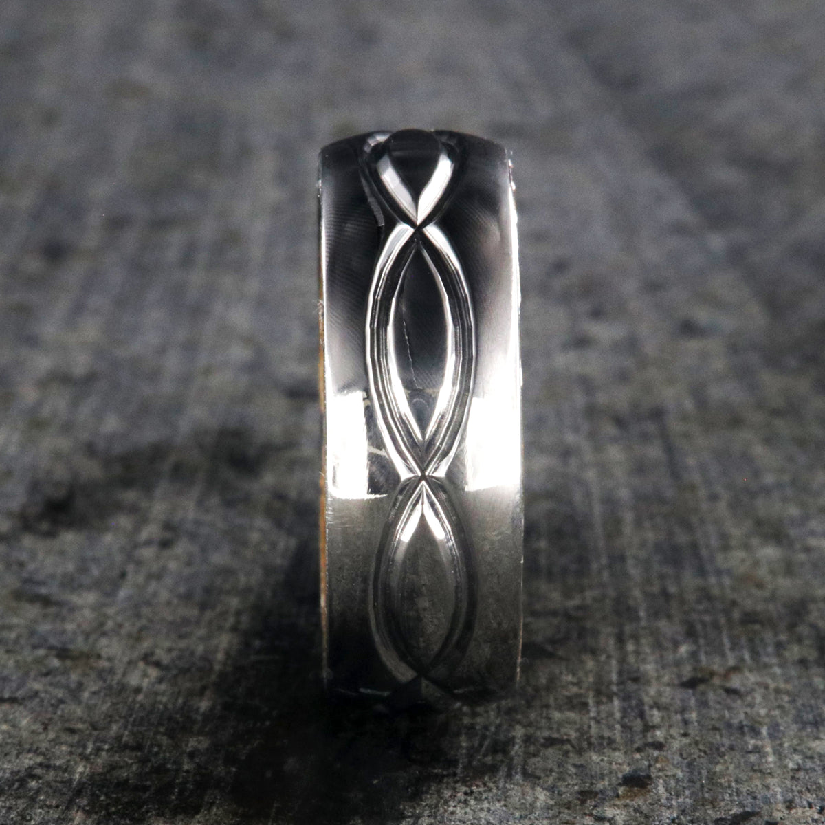 8mm wide titanium wedding band with a milled infinity design with a whiskey barrel sleeve