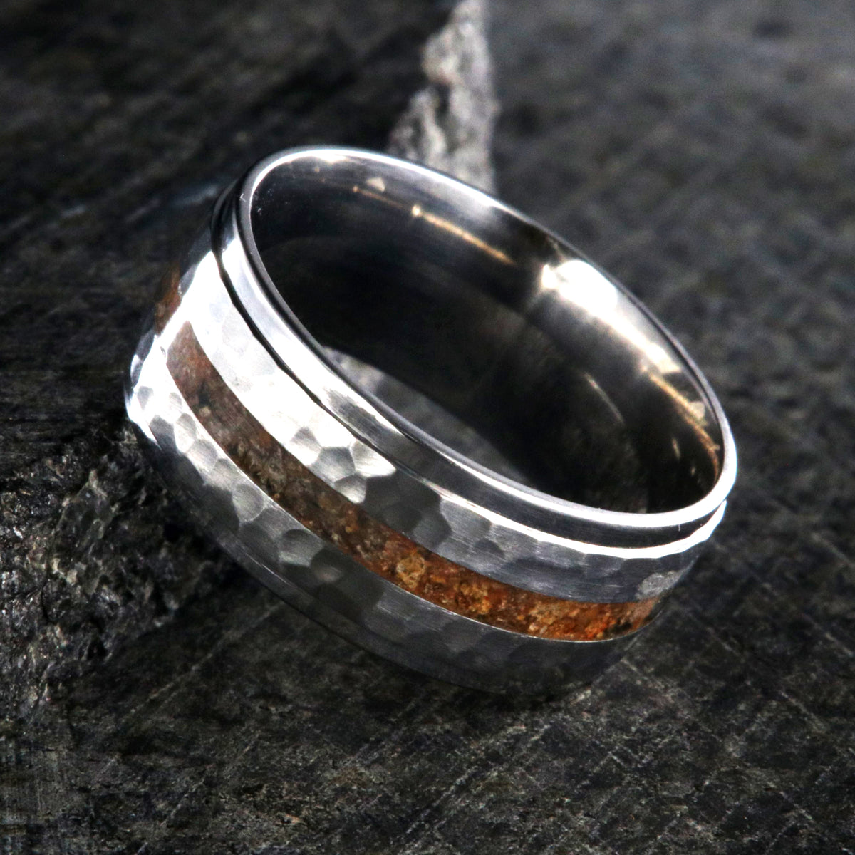 9mm wide titanium wedding band with a dinosaur bone inlay, raised center, and hammered texture