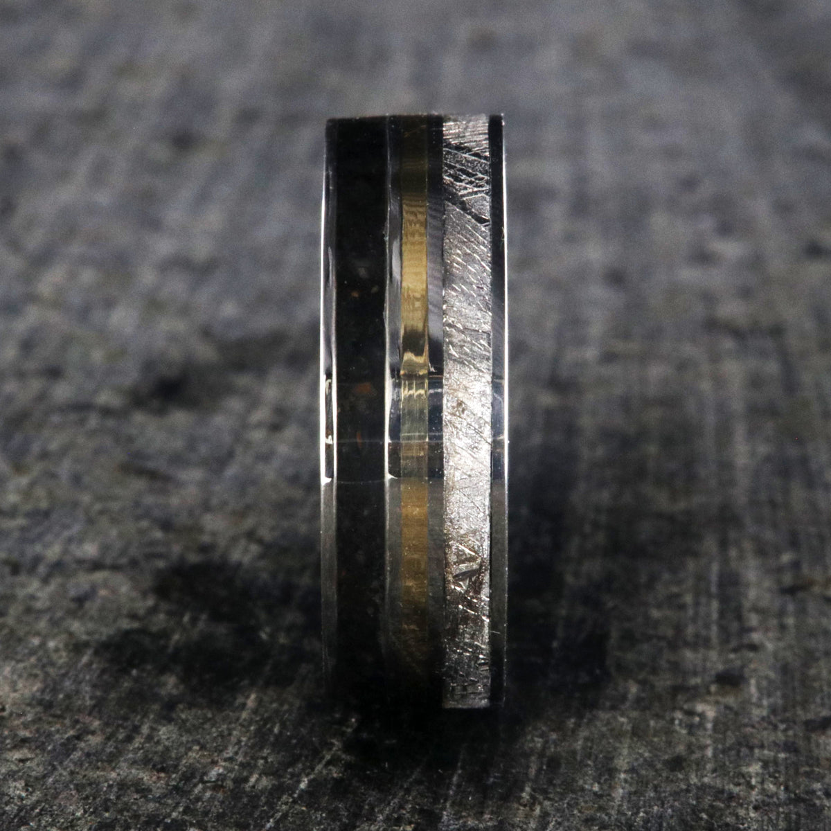 7mm wide wedding band with yellow gold center inlay, Gibeon meteorite edge, dinosaur bone edge, and cobalt sleeve