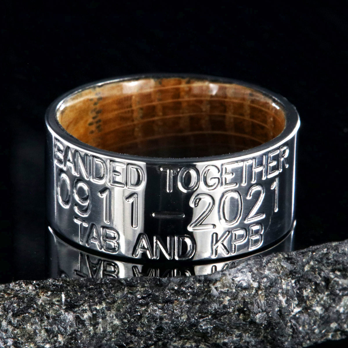 10mm wide titanium duck band with 3 lines of personalized text and a whiskey barrel sleeve