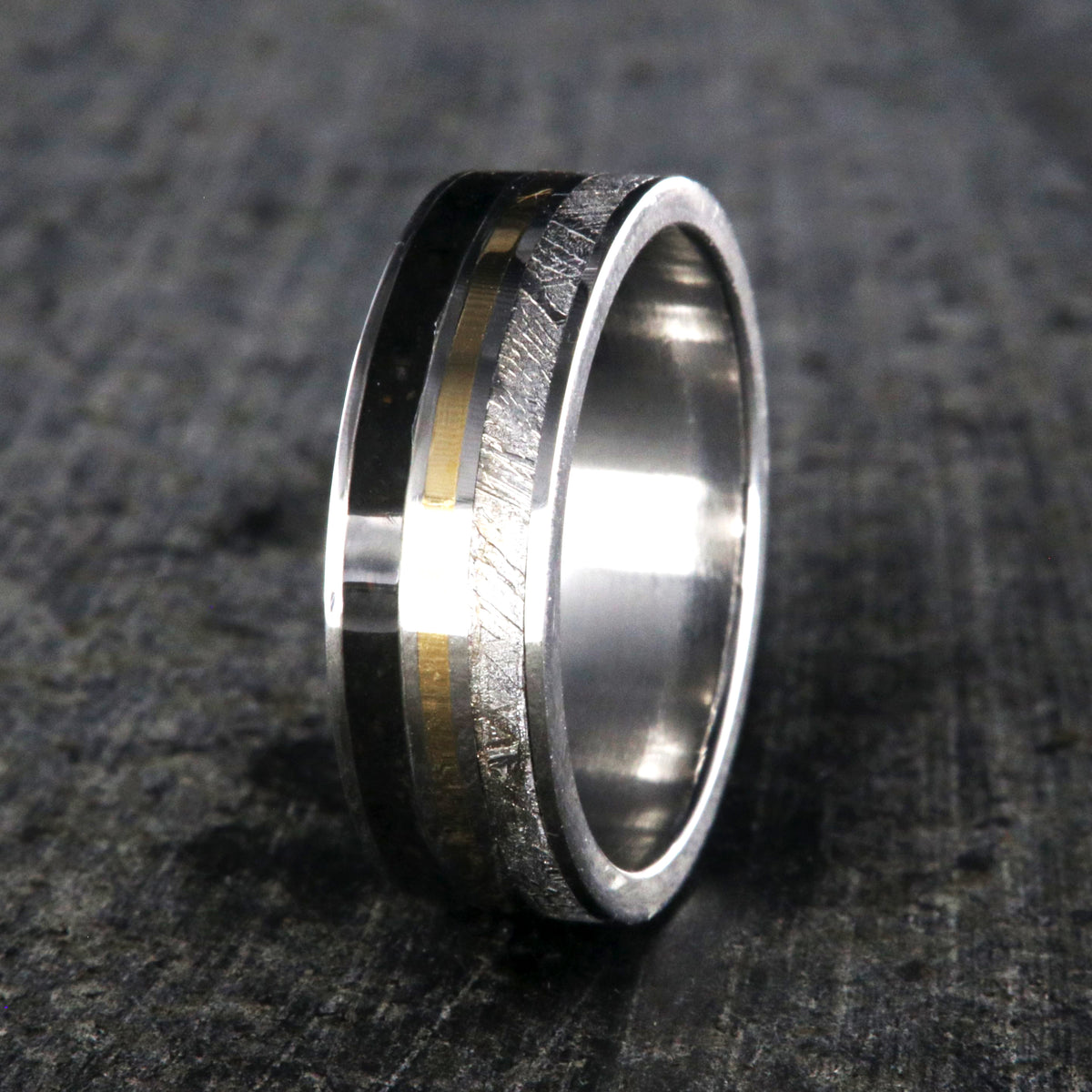 7mm wide wedding band with yellow gold center inlay, Gibeon meteorite edge, dinosaur bone edge, and cobalt sleeve