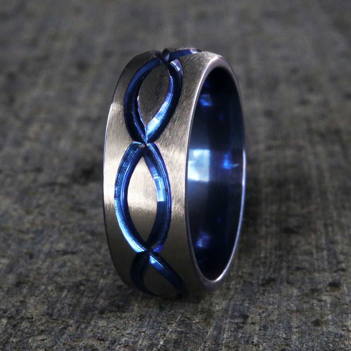 8mm wide titanium wedding band with a blue infinity design and blue sleeve