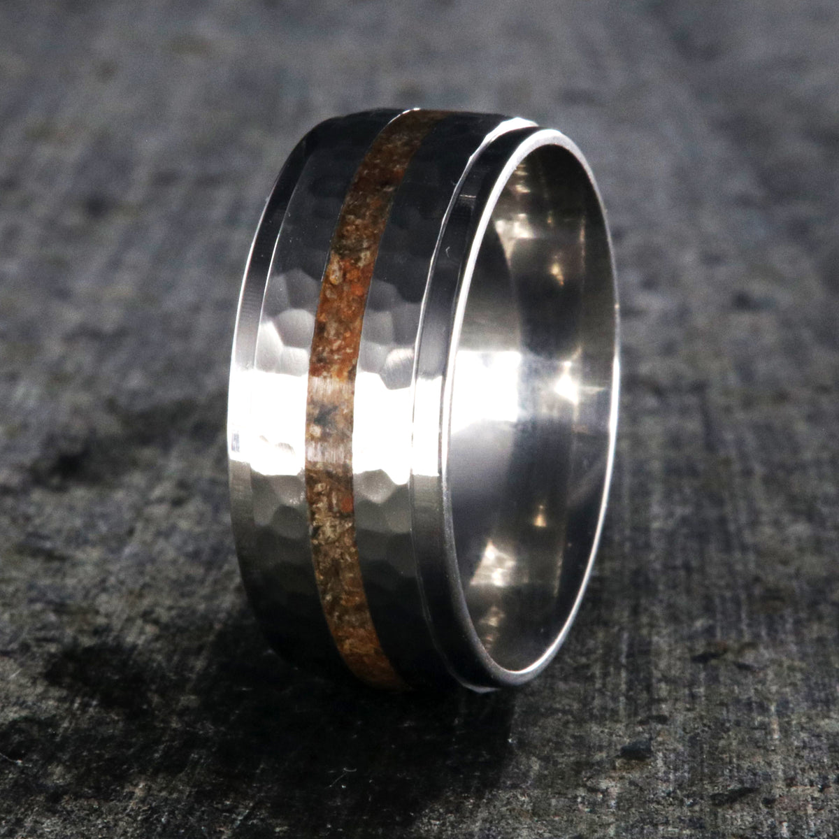 9mm wide titanium wedding band with a dinosaur bone inlay, raised center, and hammered texture