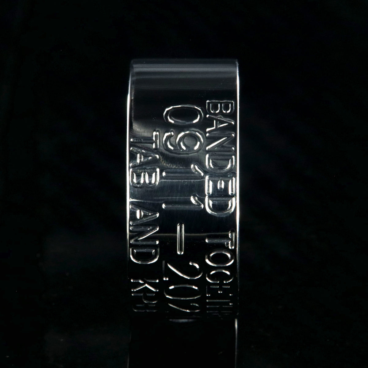 10mm wide titanium duck band with 3 lines of personalized text and a whiskey barrel sleeve