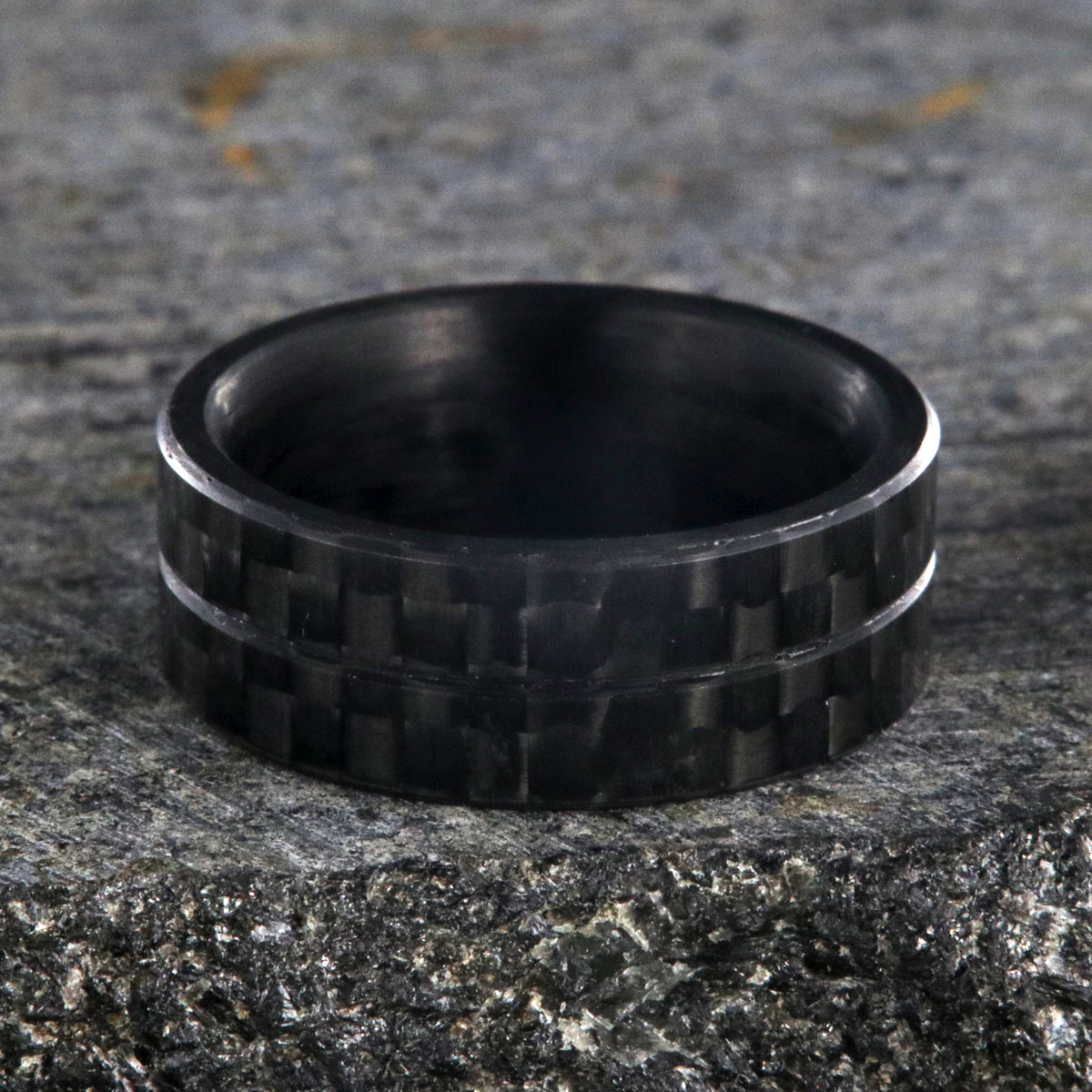 8mm wide black carbon fiber ring with a center groove and flat profile