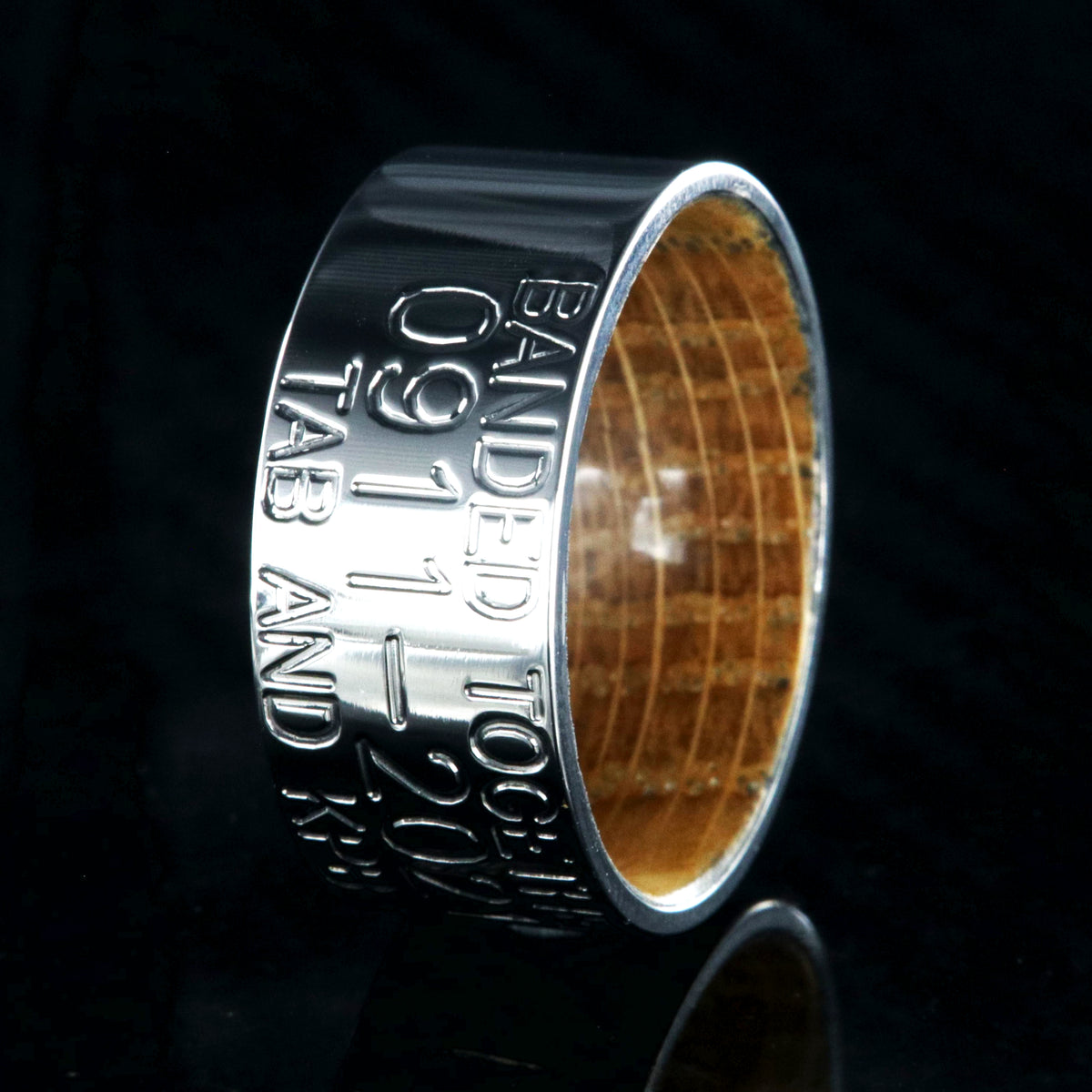 10mm wide titanium duck band with 3 lines of personalized text and a whiskey barrel sleeve