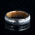 6mm wide black Damascus steel wedding band with a 1mm wide hammered white gold inlay