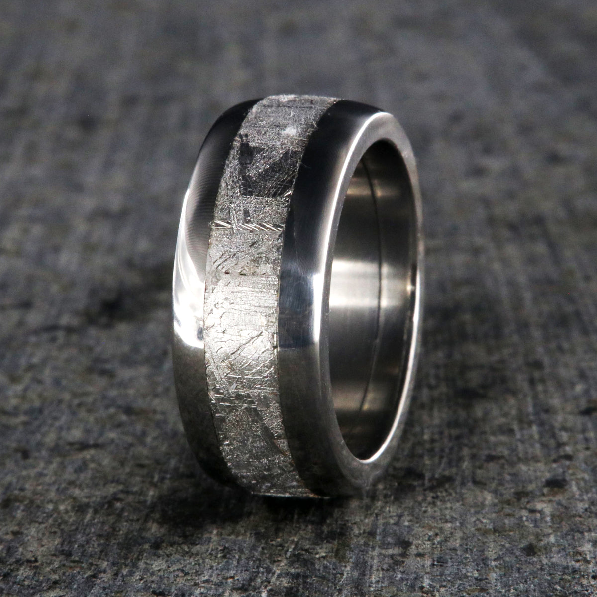 8mm wide Muonionalusta meteorite wedding band with titanium edges and sleeve