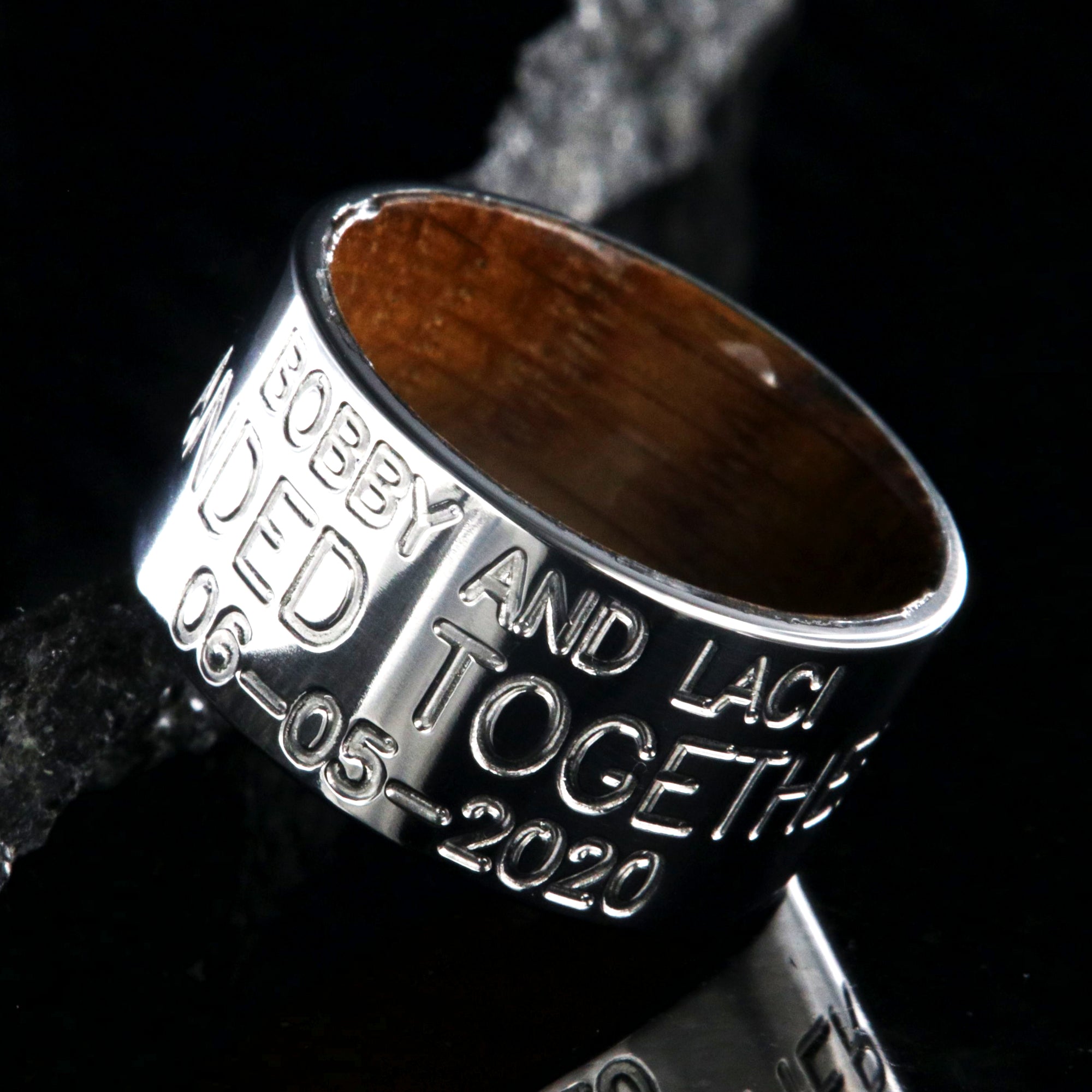 12mm wide titanium wedding band, duck band, 3 lines of custom text and a polished whiskey barrel sleeve