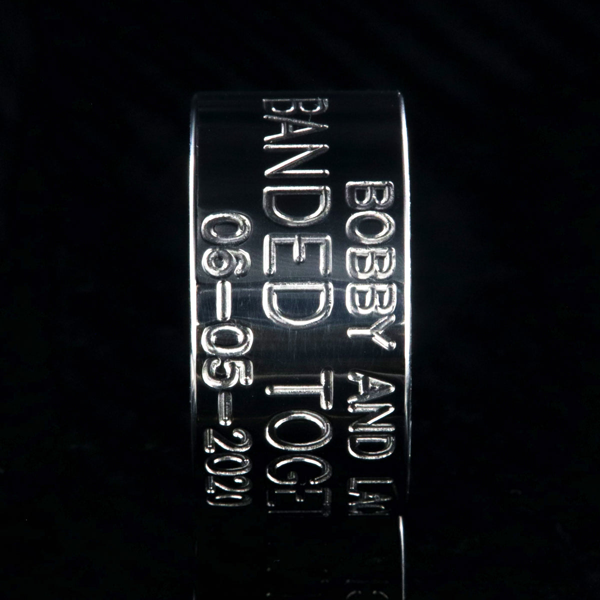 12mm wide titanium wedding band, duck band, 3 lines of custom text and a polished whiskey barrel sleeve