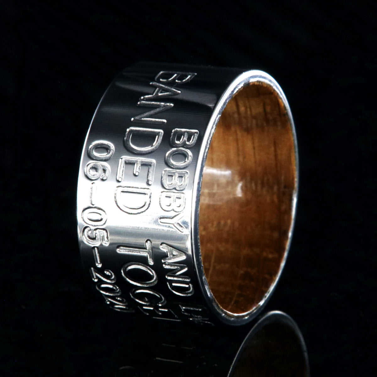 12mm wide titanium wedding band, duck band, 3 lines of custom text and a polished whiskey barrel sleeve