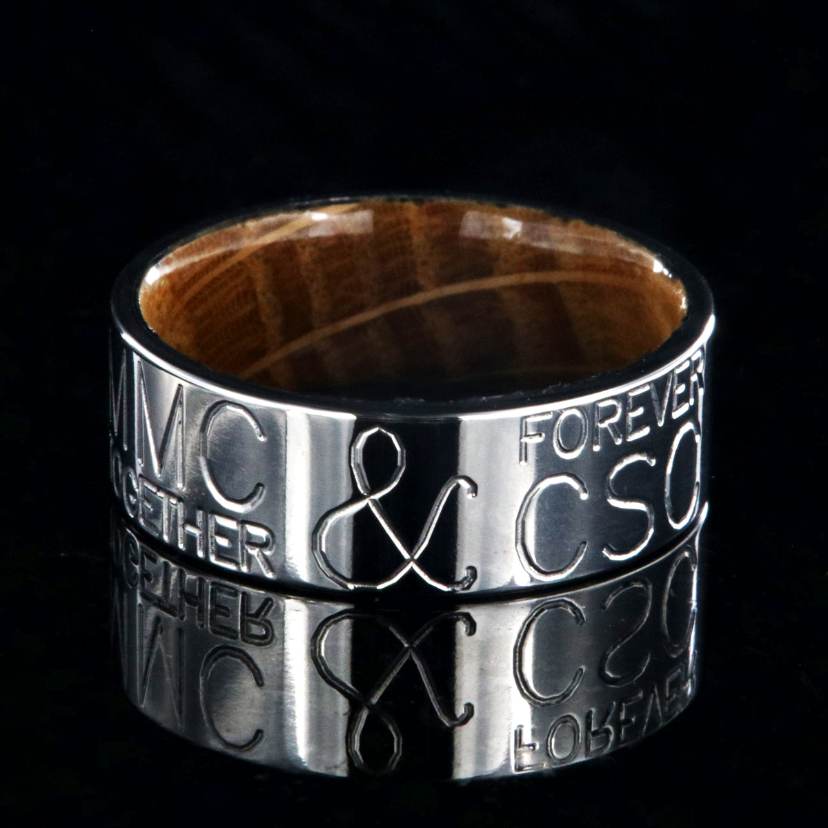 8mm wide personalized duck band ring; polished titanium with two lines of text on either side of an &amp;; polished Jack Daniel&#39;s whiskey barrel sleeve